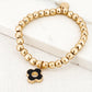 Envy Gold Bead Stretch Bracelet with Black Open Clover