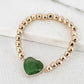 Envy Gold Alloy Bead Stretch Bracelet with Green Semi Precious Stone Heart