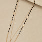 Envy long gold and black facet bead layer necklace with heart pendant