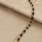 Envy long gold and black facet bead layer necklace with heart pendant