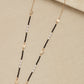 Envy long black, gold and pearl beaded necklace